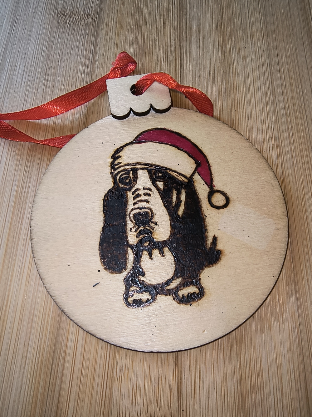 Hand Crafted Wooden Dog Ornament with Red Ribbon and Red Hat